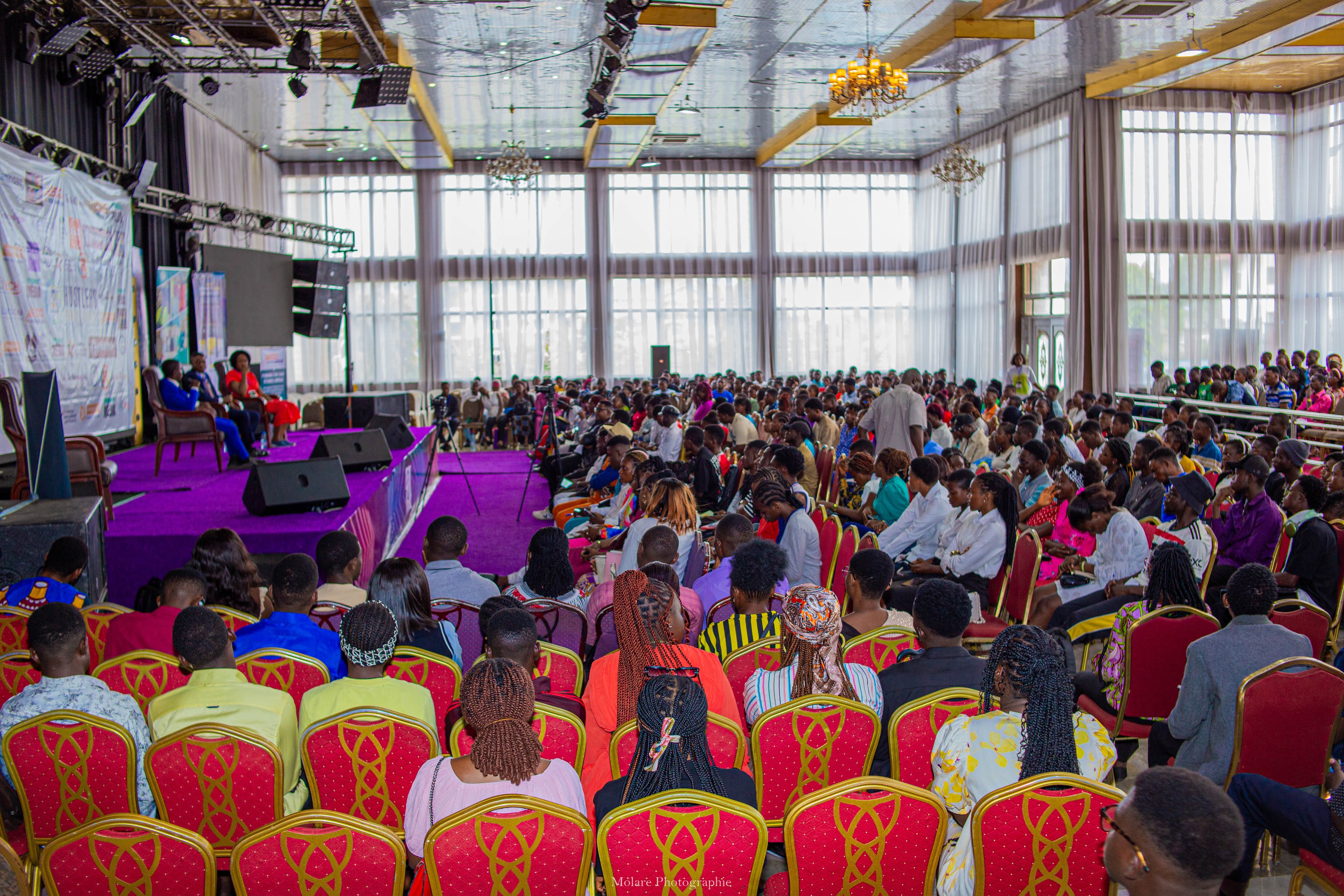 A full hall of attendees facing the stage at a past Hustlers Conference session.